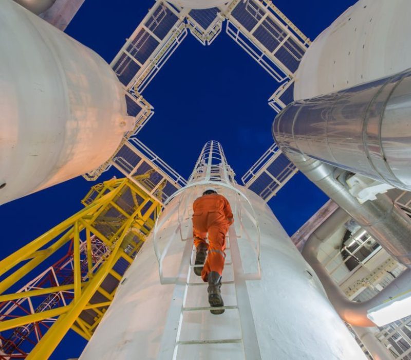 Engineering climb up to oil and gas process plant to observer gas dehydration processing in night shift